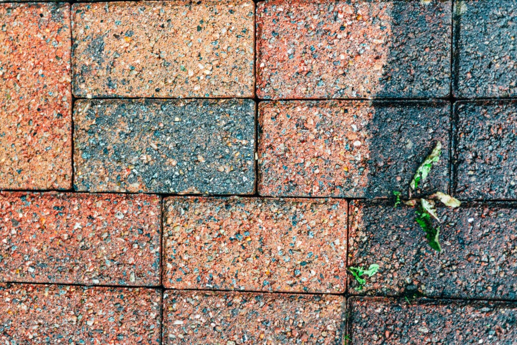 Cleaning of tiles in the garden with pressure washer